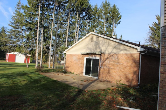 9370 Moon Rd, Saline, MI 48176 - rear view of house featuring a yard, brick siding, and a patio area