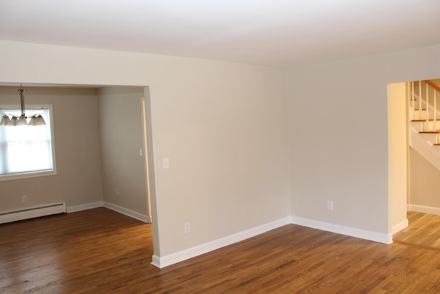 9370 Moon Rd, Saline, MI 48176 - unfurnished room featuring stairway, wood finished floors, a chandelier, and baseboards
