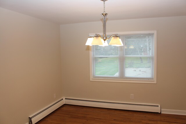 unfurnished room featuring dark wood-type flooring, plenty of natural light, and a baseboard radiator