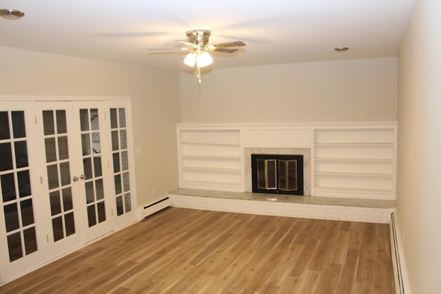 unfurnished living room with ceiling fan, a fireplace, a baseboard radiator, and hardwood / wood-style flooring