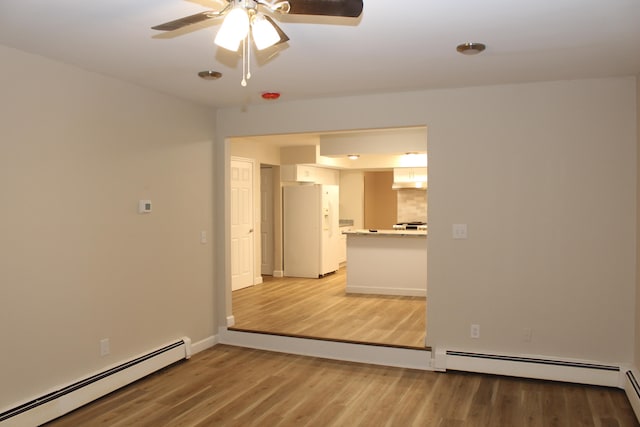 empty room with light wood-type flooring, baseboard heating, and ceiling fan