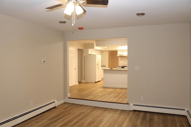 9370 Moon Rd, Saline, MI 48176 - unfurnished room with a baseboard radiator, light wood-type flooring, and a ceiling fan