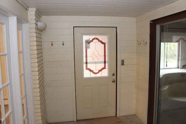 doorway with wooden walls