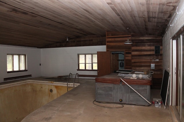 misc room featuring wooden ceiling, concrete flooring, and vaulted ceiling