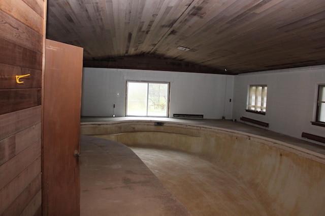9370 Moon Rd, Saline, MI 48176 - unfurnished room featuring a baseboard radiator, lofted ceiling, concrete flooring, and wooden ceiling