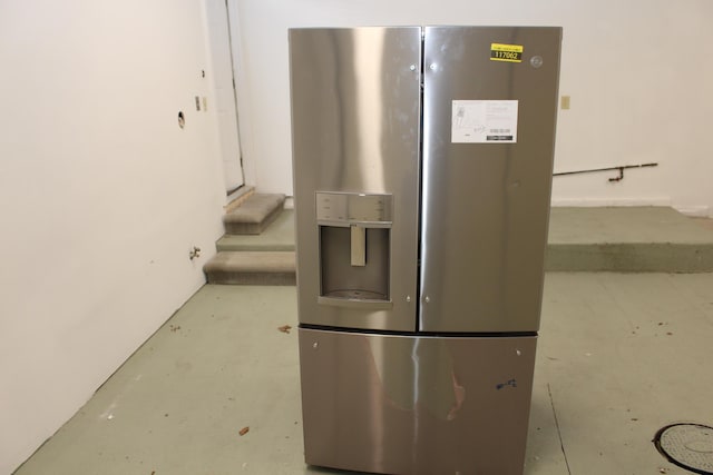 9370 Moon Rd, Saline, MI 48176 - kitchen view of stainless steel fridge with ice dispenser and finished concrete flooring
