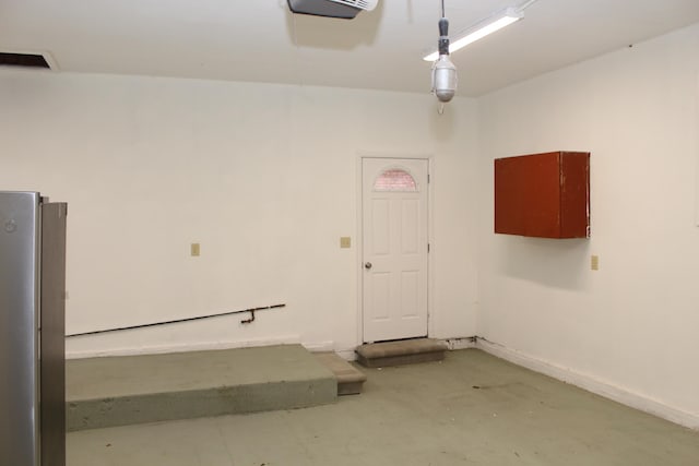 9370 Moon Rd, Saline, MI 48176 - garage featuring freestanding refrigerator and baseboards