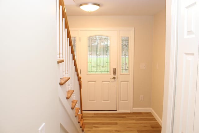 9370 Moon Rd, Saline, MI 48176 - entryway featuring light wood-type flooring, stairs, and baseboards
