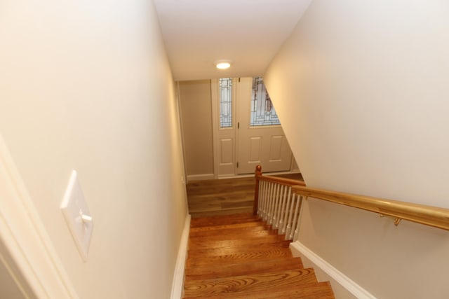 stairs with hardwood / wood-style floors