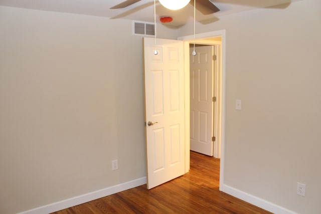 unfurnished room featuring ceiling fan and hardwood / wood-style flooring