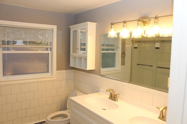 9370 Moon Rd, Saline, MI 48176 - bathroom featuring tile walls, toilet, a shower, double vanity, and wainscoting