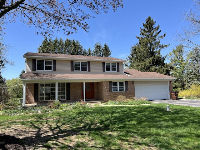 9370 Moon Rd, Saline, MI 48176 - traditional home featuring an attached garage, driveway, and brick siding