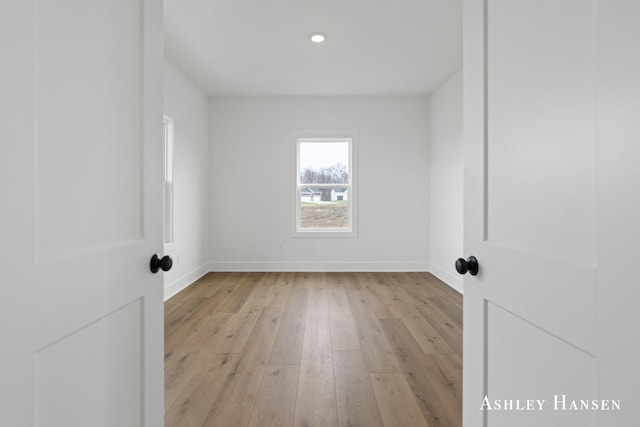 empty room with light hardwood / wood-style flooring