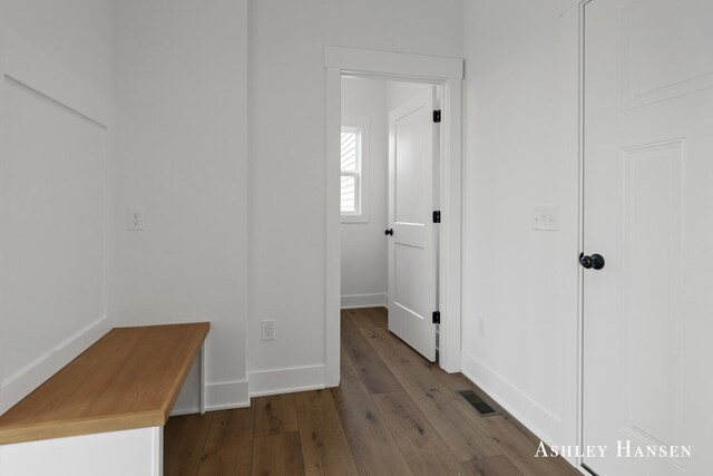 hallway with hardwood / wood-style flooring