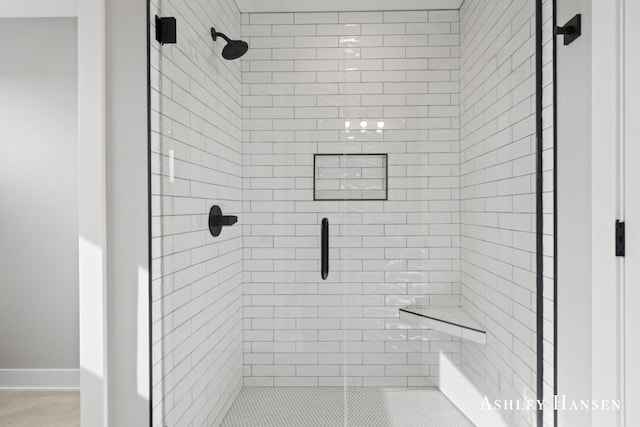 bathroom with a shower with shower door