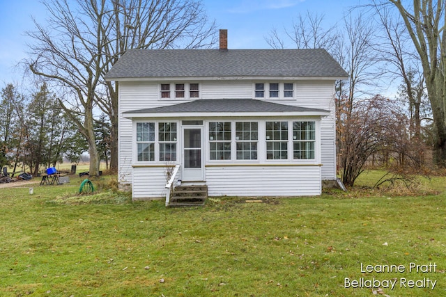 exterior space featuring a sunroom and a front yard