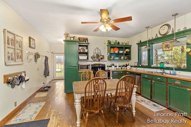 dining room featuring wood-type flooring, sink, plenty of natural light, and ceiling fan