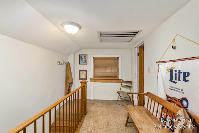 hallway featuring light carpet and vaulted ceiling