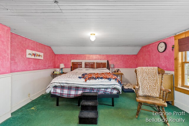 carpeted bedroom with vaulted ceiling