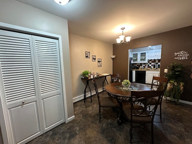 dining area featuring a baseboard radiator, a notable chandelier, and sink