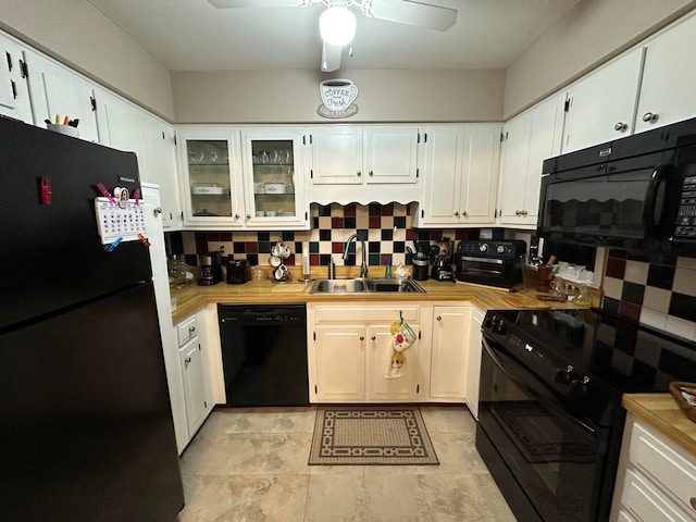 kitchen featuring black appliances, sink, white cabinetry, and backsplash