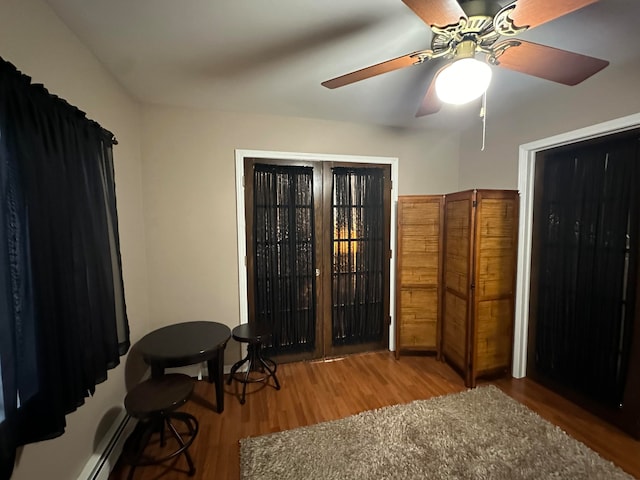 sitting room featuring baseboard heating, ceiling fan, and light hardwood / wood-style floors