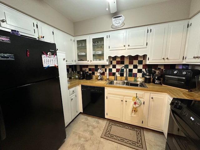 kitchen featuring sink, white cabinets, and black appliances