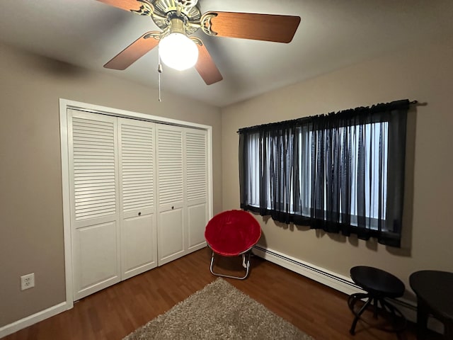 sitting room with baseboard heating, ceiling fan, and hardwood / wood-style floors