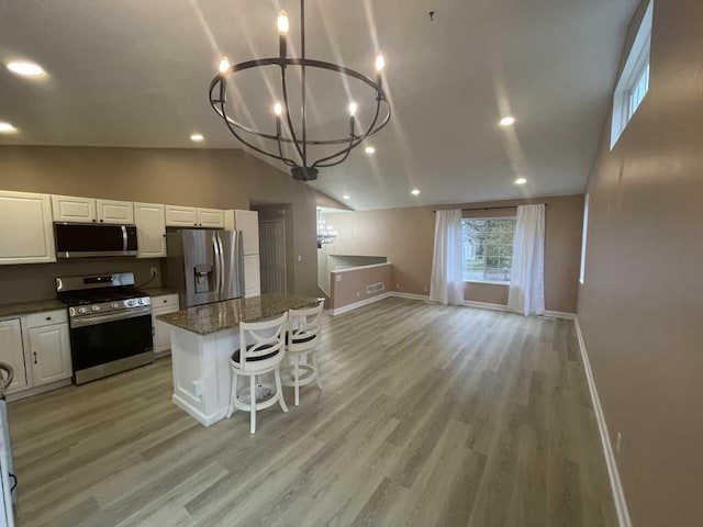 kitchen with white cabinets, a center island, light wood-type flooring, and stainless steel appliances