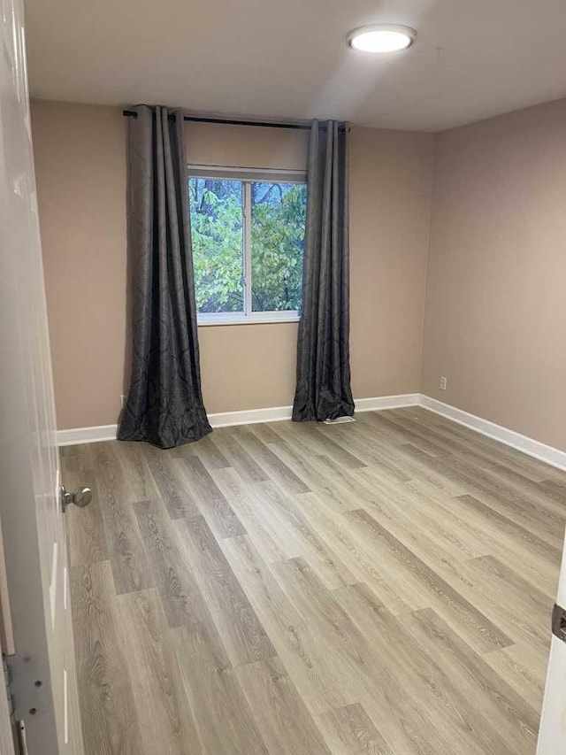 spare room with light hardwood / wood-style flooring