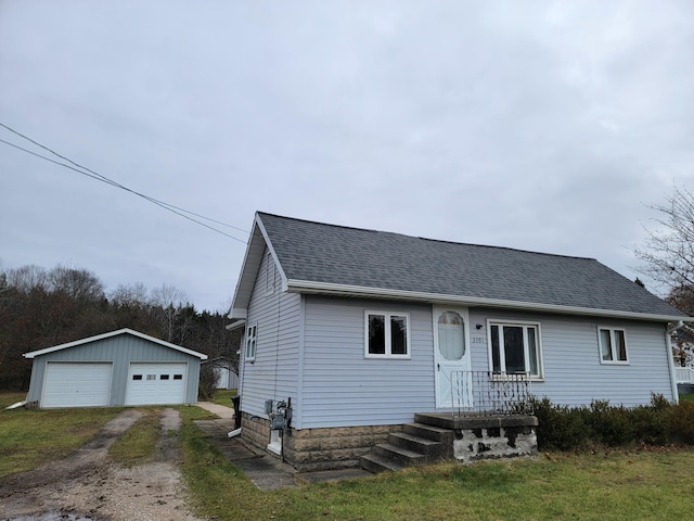 view of front of property with an outdoor structure and a garage