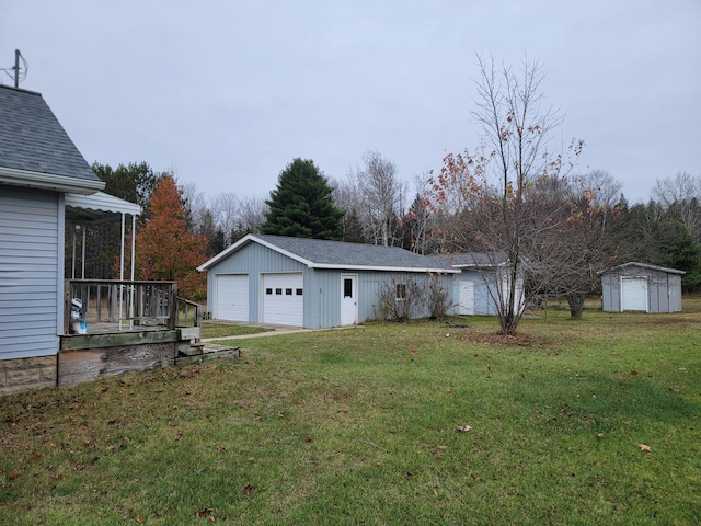 view of yard featuring an outbuilding and a garage