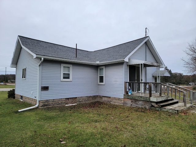 back of house with a lawn