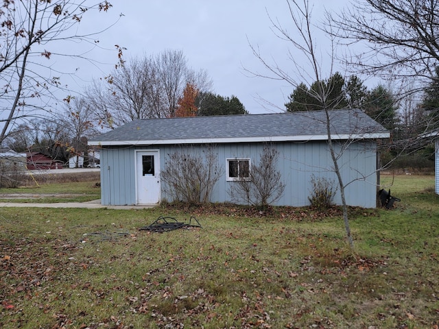 view of outdoor structure featuring a lawn