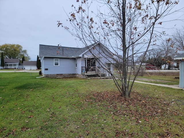 back of property featuring a lawn