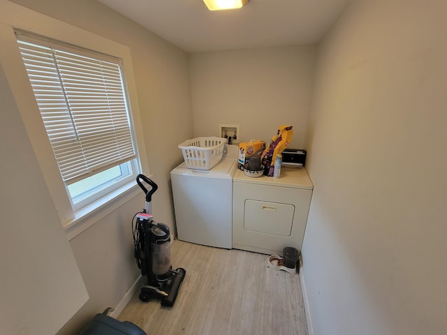 laundry area featuring light wood-type flooring and washing machine and dryer