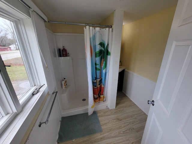 bathroom featuring hardwood / wood-style floors and curtained shower