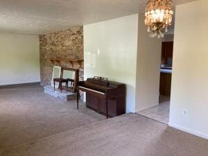 misc room featuring carpet flooring, a large fireplace, and a chandelier