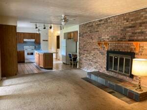 interior space featuring ceiling fan and a brick fireplace