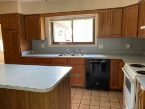 kitchen with electric range, dishwasher, light tile patterned floors, and sink