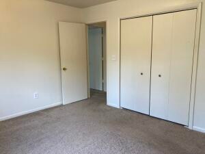 unfurnished bedroom with carpet floors and a closet