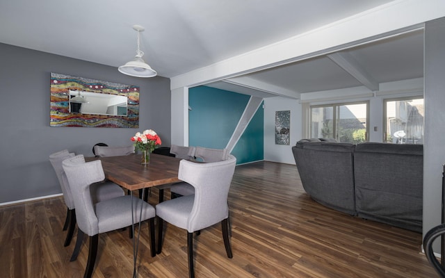 dining space featuring beamed ceiling and dark hardwood / wood-style floors