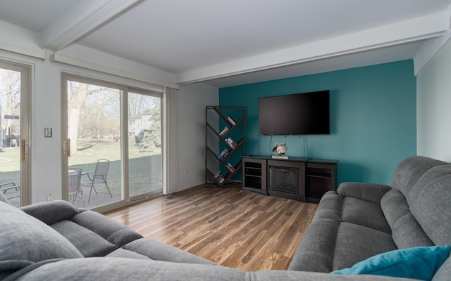 living room featuring wood-type flooring and beam ceiling