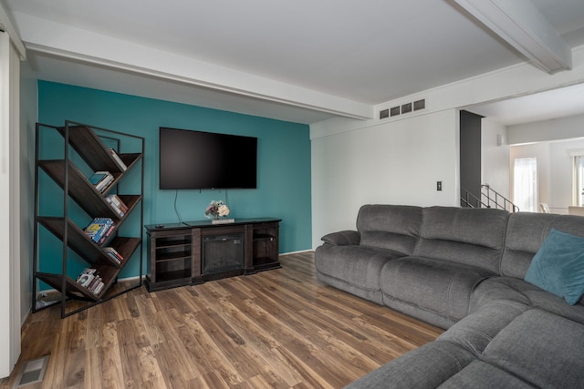 living room featuring hardwood / wood-style floors and beamed ceiling