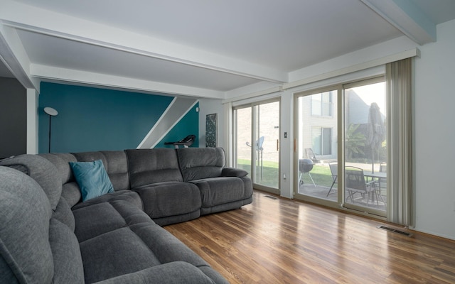 living room with beam ceiling and hardwood / wood-style floors