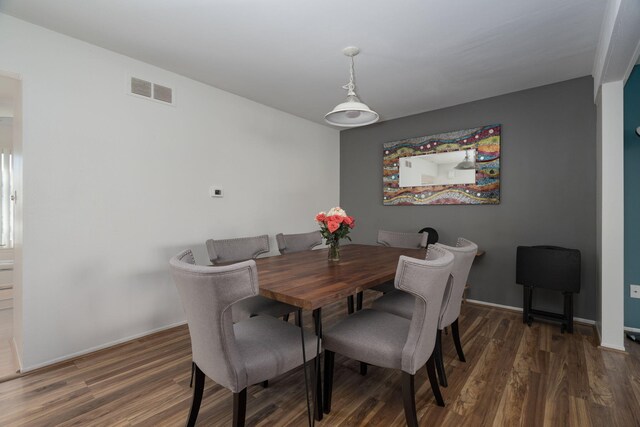 dining space with dark hardwood / wood-style floors