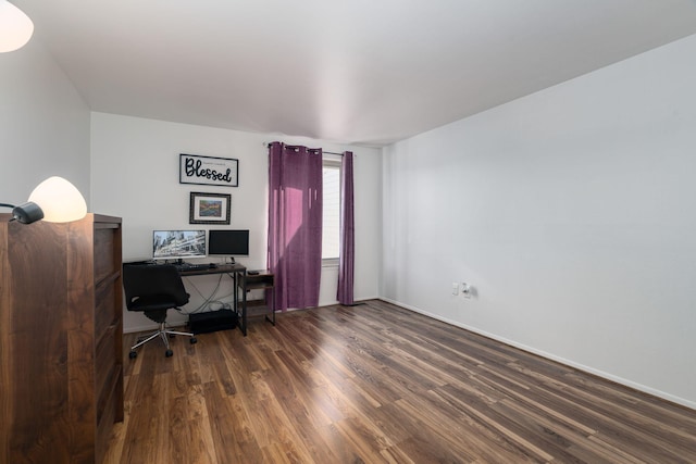 home office with dark hardwood / wood-style flooring