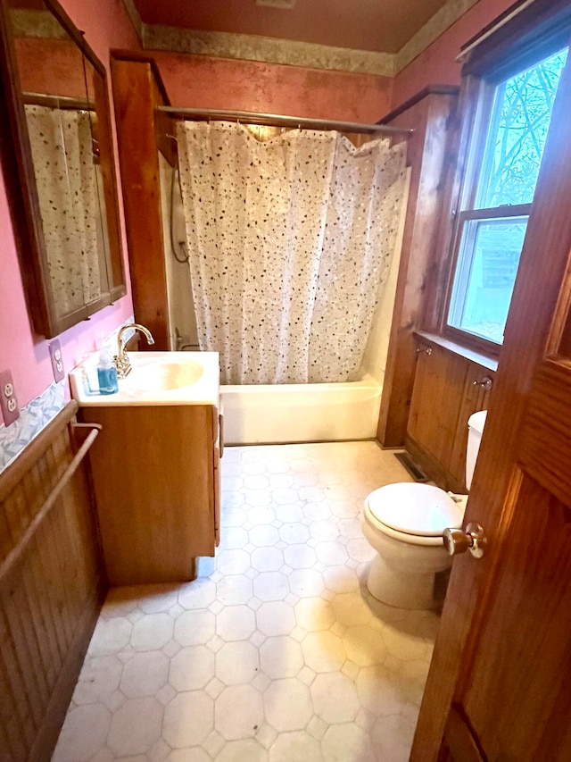 full bathroom with shower / bath combo, vanity, and toilet