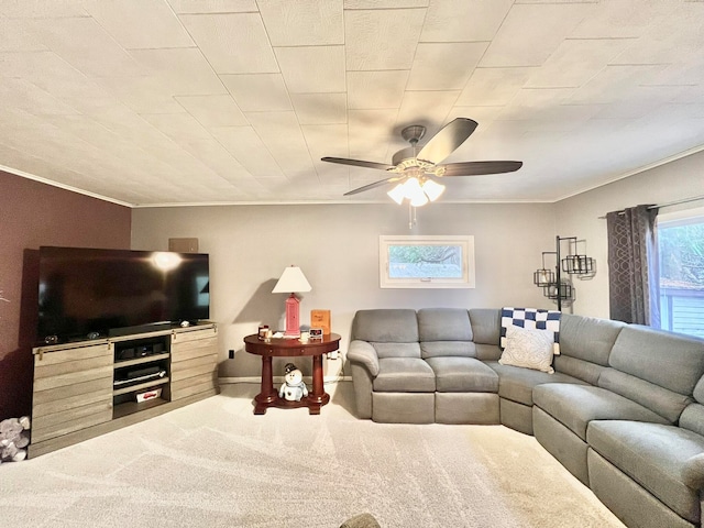 carpeted living room featuring ceiling fan and ornamental molding