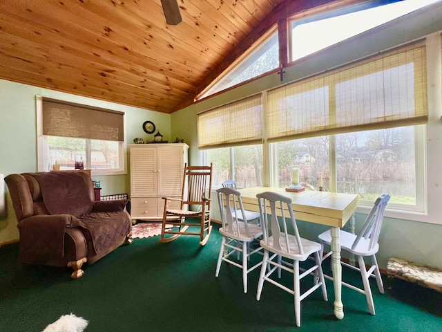 dining room featuring carpet floors, plenty of natural light, and lofted ceiling